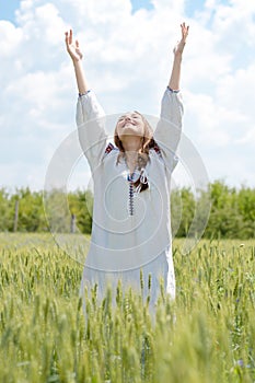 Young happy girl in traditional ukrainian dress outdoors