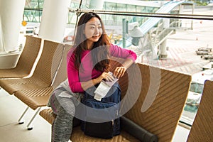 Young happy girl waiting for departure in international airport.