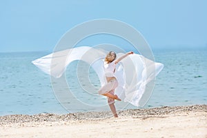 Young happy girl with white wings