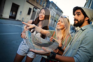 Young happy group of friends sightseeing in city