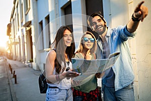 Young happy group of friends sightseeing in city