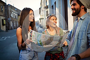 Young happy group of friends sightseeing in city