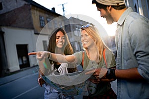 Young happy group of friends sightseeing in city