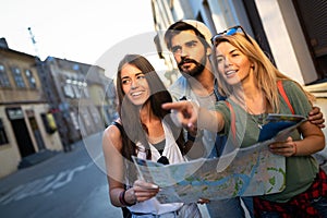 Young happy group of friends sightseeing in city