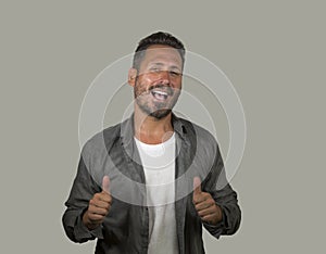 Young happy and handsome 40s man with blue eyes and beard  in casual shirt posing in cool attitude smiling cheerful and confident