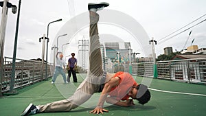 Young happy hipster perform break dancing or foot step with friend. Sprightly.