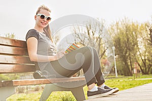 Young happy hipster with sunglasses enjoying freetime outside