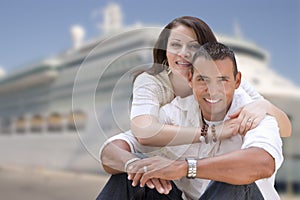 Young Happy Hispanic Couple In Front of Cruise Ship