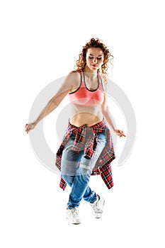 Young happy woman dancing against white background