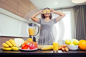 Young happy indian woman making healthy drinks on juicer smoothie jar in modern home