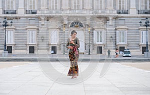 Young happy Indonesian woman from Bali having vacation in Europe - beautiful and exotic Balinese tourist girl dancing in