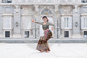 Young happy Indonesian woman from Bali having vacation in Europe - beautiful and exotic Balinese tourist girl dancing in