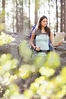 Young happy jogger looking at map