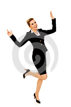Young happy jumping businesswoman with hands up