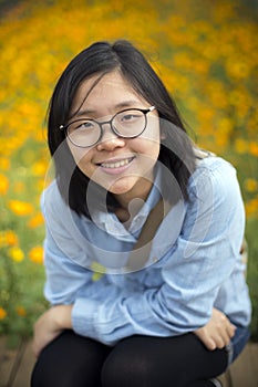 Young happy lady at field of flowers