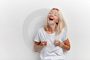 Young happy laughing funny crazy woman showing fico, having fun photo