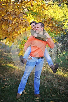 Young happy love couple in autumn park