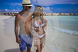 Young happy lovers on romantic travel honeymoon having fun on vacation summer holidays romance.