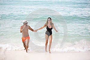 Young happy lovers on romantic travel honeymoon having fun on vacation summer holidays romance.