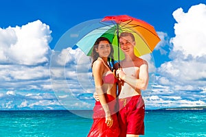 Young happy loving couple having fun in the tropical beach with