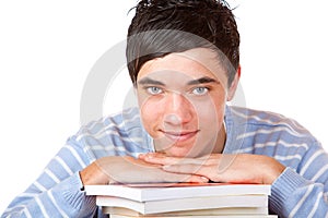 Young happy male student leaning on study books