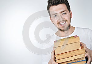 Young happy man carrying books