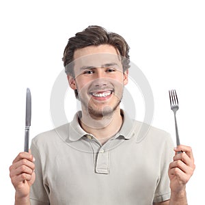Young happy man holding a fork and a knife