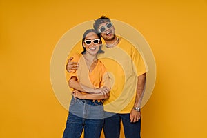 Young happy man hugging his smiling girlfriend with folded arms