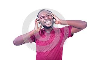 Young happy man listening to music in headphones smiling