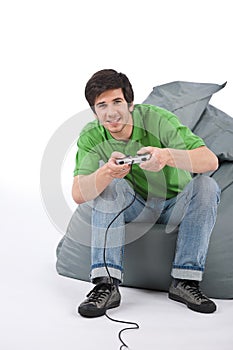 Young happy man playing video game