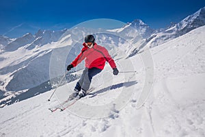 Young happy man skiing in Lenzerheide ski resort, Switzerland.