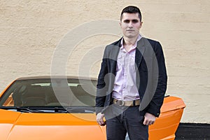 Young happy man standing near luxury sport car