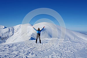 Young happy man at the top of Kopa Kondracka during winter, Zakopane, Tatry mountains, Poland