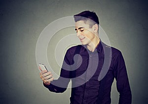 Young happy man using a mobile phone