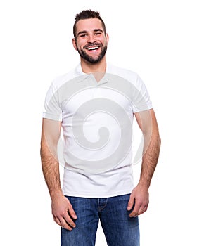 Young happy man in a white polo shirt photo