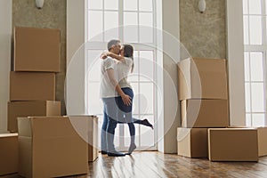 Young happy millennial couple students move into their first new owners home. Simple white background of urban apartment