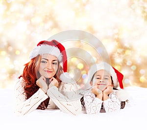 A young and happy mother and daughter on a Christmas background
