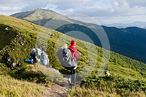 Young happy mother hold little traveller on back - baby girl in carrying backpack enjoying travel adventure, Hiking activity with