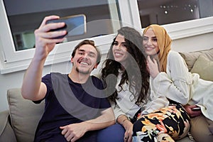Young happy, muslims taking selfie in house