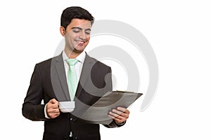 Young happy Persian businessman reading clipboard while holding