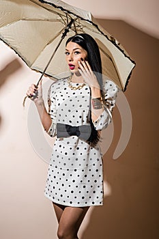 Young happy pinup style woman with umbrella
