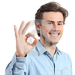 Young happy positive teenager man gesturing ok photo
