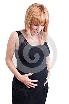 Young happy pregnant woman holding her eight months belly