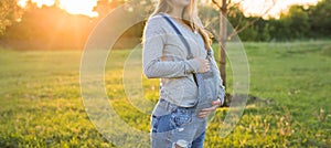 Young happy pregnant woman relaxing and enjoying life in autumn nature