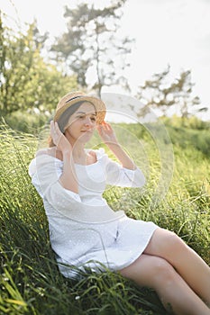 Young happy pregnant woman relaxing and enjoying life in nature. Outdoor shot. Copyspace