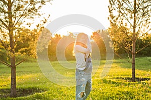 Young happy pregnant woman relaxing and enjoying life in nature. Outdoor shot. Copyspace