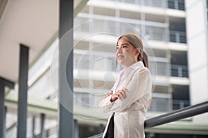 Young happy pretty smiling professional business woman asian, happy confident positive female entrepreneur standing on