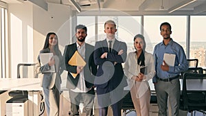 Young happy professional team business people standing in office. Portrait