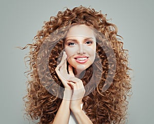 Young happy redhead woman with long healthy curly hair. Hair care concept