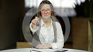 Young Happy Smiling Business Woman Or Real Estate Agent Showing Keys From New House. Isolated Over Background. Focus On